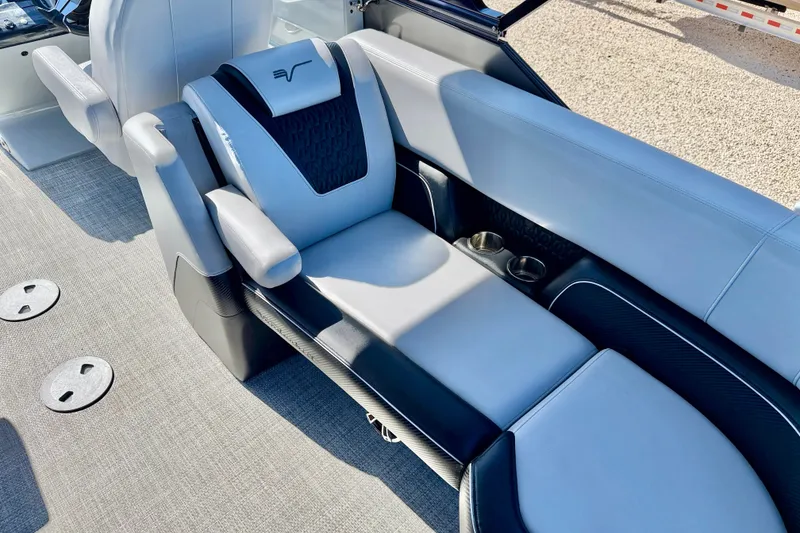 Slide: The Image of Luxurious seating in the 2027 Vanderbilt 23QS boat, featuring sleek design and cup holders. - 16