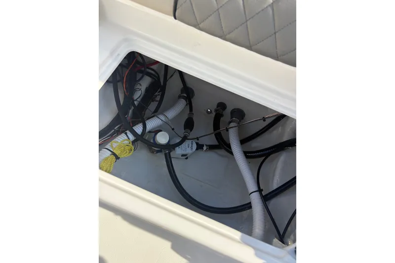 Slide: The Image of Interior view of 2027 Key West 179 FS boat showing wiring and hoses. - 13
