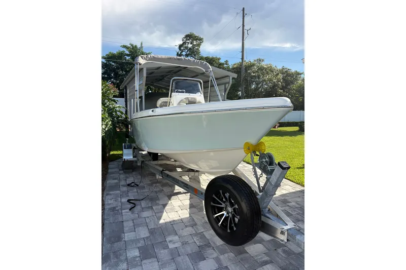 Slide: The Image of 2027 Key West 179 FS boat on trailer, parked on paved driveway. - 18