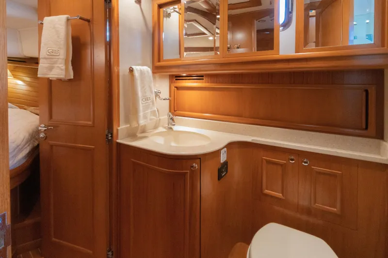 Slide: The Image of Luxurious 2010 Grand Banks 41 Heritage EU yacht bathroom with wooden cabinetry and modern fixtures. - 22
