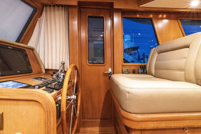 Slide: The Image of Luxurious interior of 2010 Grand Banks 41 Heritage EU yacht with wooden helm and seating. - 14