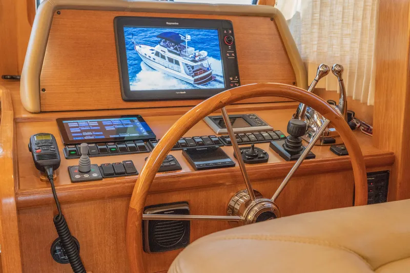 Slide: The Image of Helm of 2010 Grand Banks 41 Heritage EU with navigation equipment and wooden steering wheel. - 15