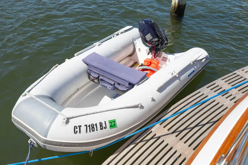 Slide: The Image of Inflatable dinghy docked beside a Grand Banks 41 Heritage EU, 2010 model. - 43