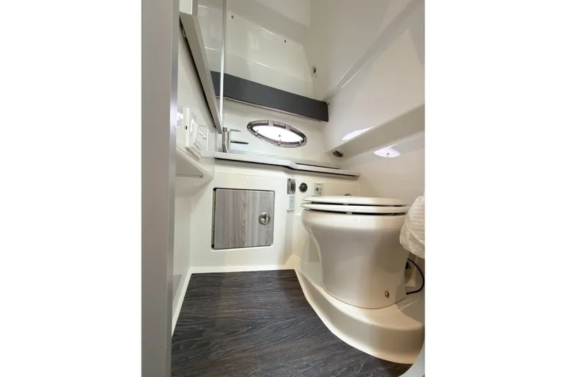 Slide: The Image of 2020 Formula 330 Crossover Bowrider I/O bathroom interior with modern fixtures and wood flooring. - 13