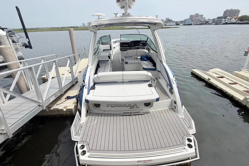 Slide: The Image of 2020 Formula 330 Crossover Bowrider I/O docked at marina, rear view. - 5