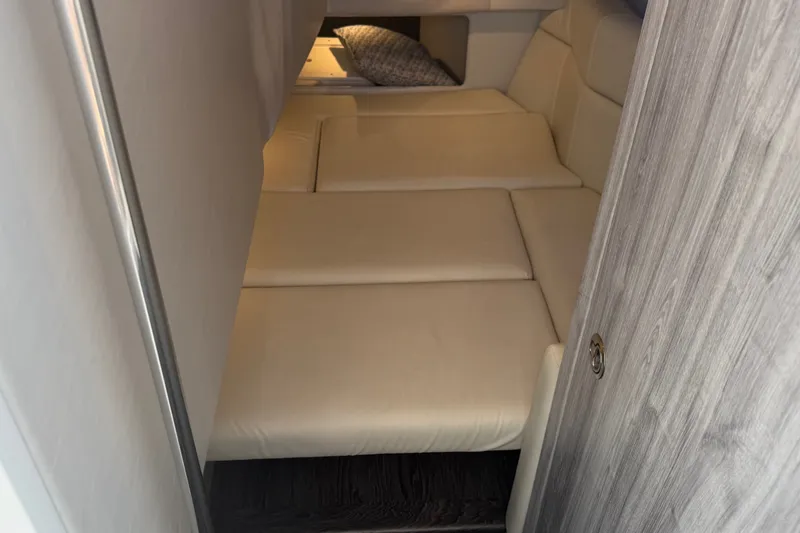 Slide: The Image of 2020 Formula 330 Crossover Bowrider I/O cabin interior with beige seating. - 16