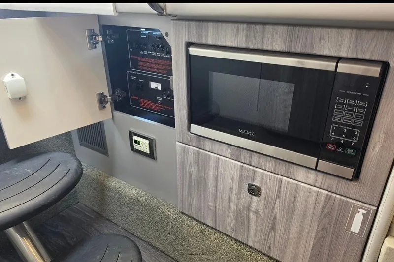 Slide: The Image of 2020 Formula 330 Crossover Bowrider I/O interior with microwave and control panel. - 21
