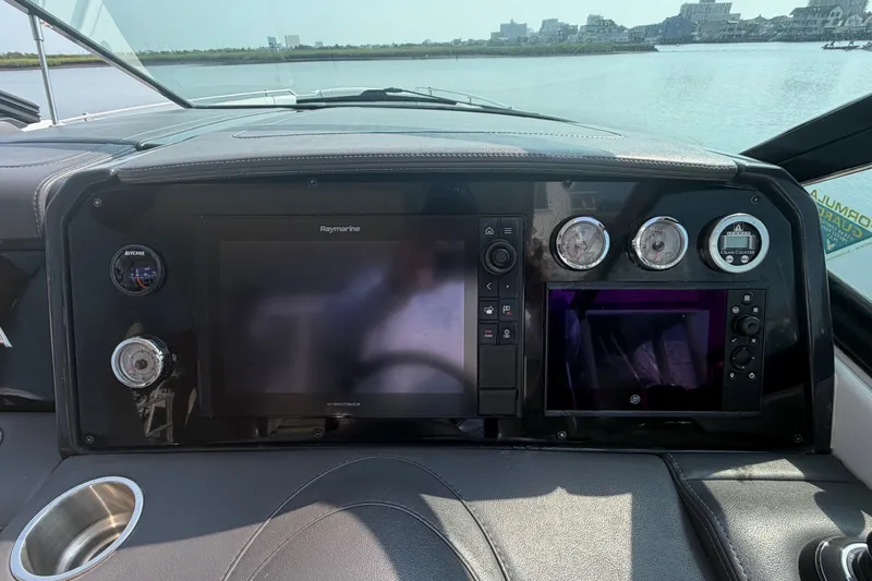 Slide: The Image of Dashboard of 2020 Formula 330 Crossover Bowrider I/O with navigation and control panels. - 11