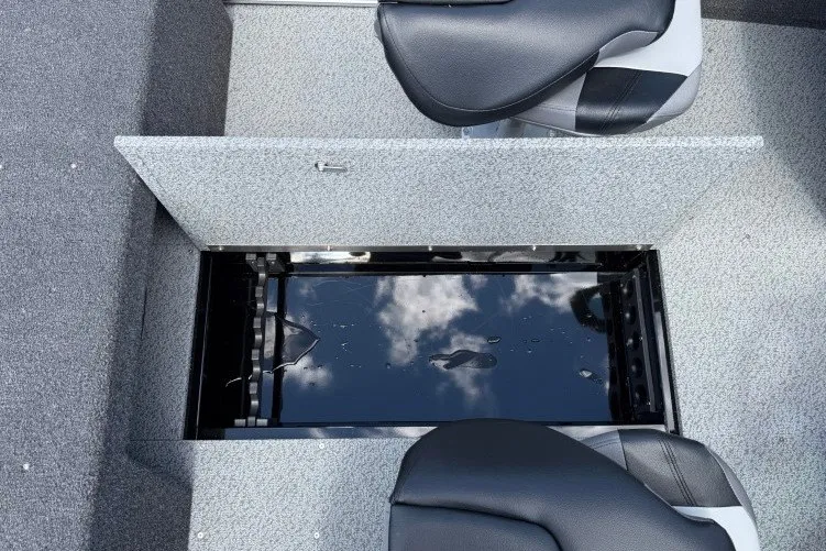 Slide: The Image of 2026 Crestliner 1650 Kodiak WT boat interior with open storage compartment and seating. - 11