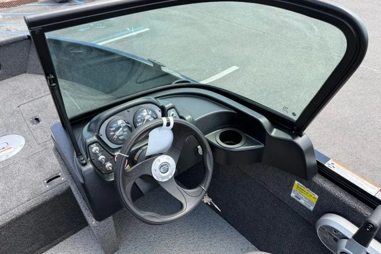 Slide: The Image of 2026 Crestliner 1650 Kodiak WT boat cockpit with steering wheel and dashboard controls. - 9