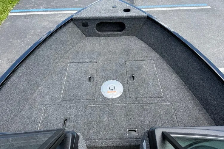 Slide: The Image of 2026 Crestliner 1650 Kodiak WT boat interior with carpeted deck and storage compartments. - 3