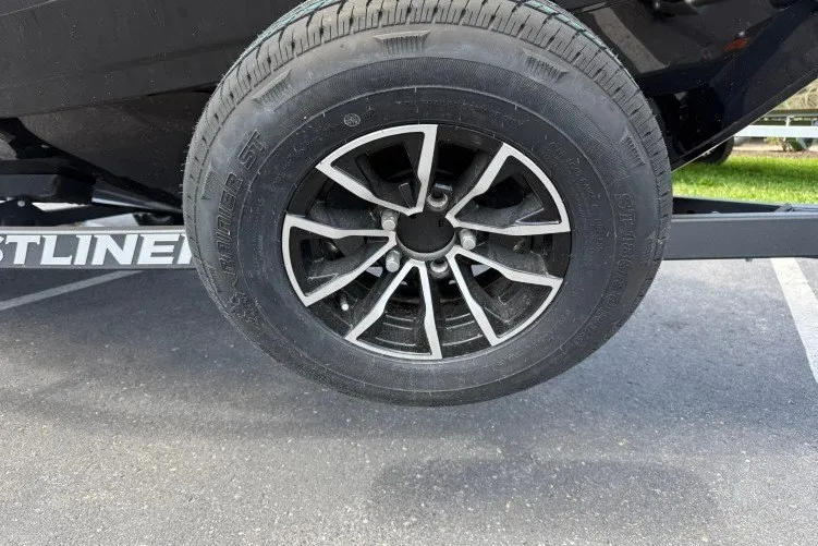 Slide: The Image of Trailer wheel of 2026 Crestliner 1650 Kodiak WT on pavement. - 14
