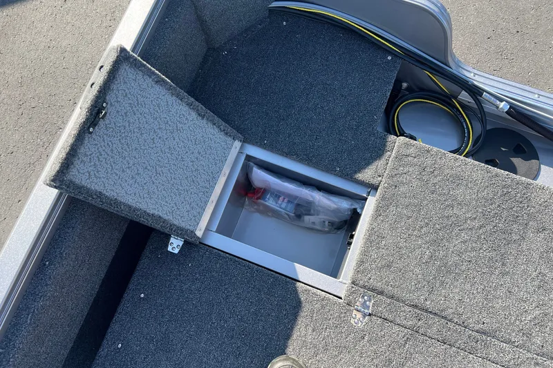 Slide: The Image of Open storage compartment on 2026 Crestliner 1650 Kodiak WT boat, showcasing interior space. - 13