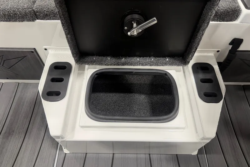 Slide: The Image of Storage compartment on 2026 Vexus AVX 2085S boat, featuring carpeted interior and secure latch. - 14