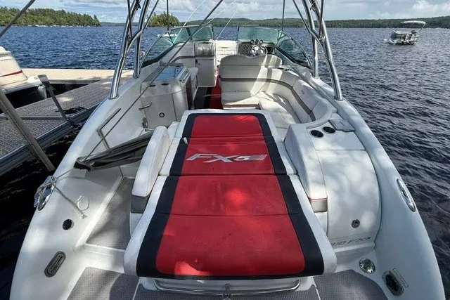 Slide: The Image of 2011 Formula 310 FX5 Bowrider on lake, featuring spacious seating and sleek design. - 14