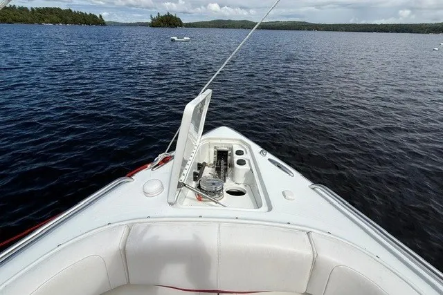 Slide: The Image of 2011 Formula 310 FX5 Bowrider on a serene lake with open storage compartment. - 15