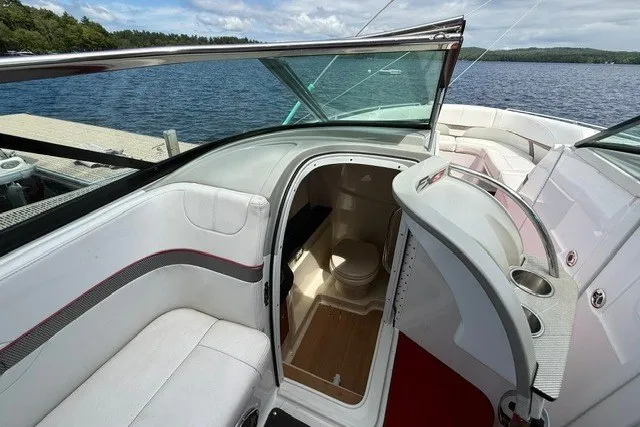Slide: The Image of 2011 Formula 310 FX5 Bowrider interior with open cabin door, lake view. - 16