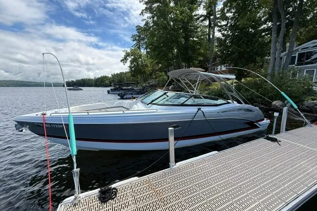 The Image of 2011 Formula 310 FX5 Bowrider docked on a serene lake with lush trees. - 0