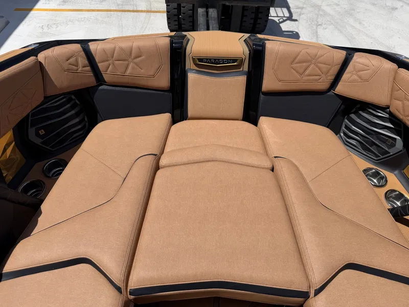 Slide: The Image of The image shows the luxurious, cushioned aft deck of a Nautique Super Air Nautique G23 Paragon. - 31
