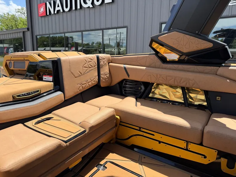 Slide: The Image of The image shows the luxurious interior of a Nautique Super Air Nautique G23 Paragon with beige upholstery. - 19