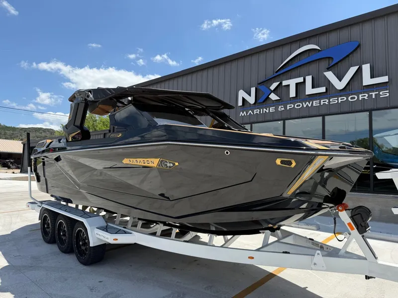 Slide: The Image of A sleek black boat on a trailer in front of a building. It features gold accents. - 5