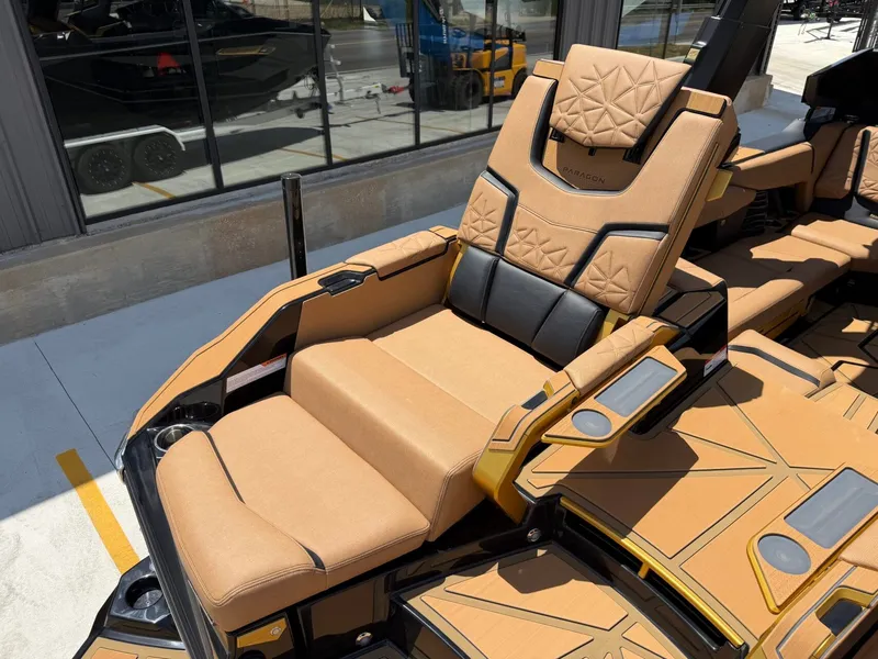 Slide: The Image of Luxurious seating area with cushioned brown and black seats on a modern boat. - 16