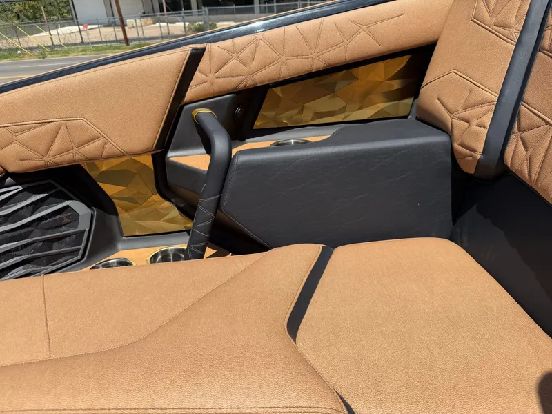 Slide: The Image of Luxurious interior with brown upholstery and geometric patterns in the Nautique Super Air Nautique G23 Paragon. - 29