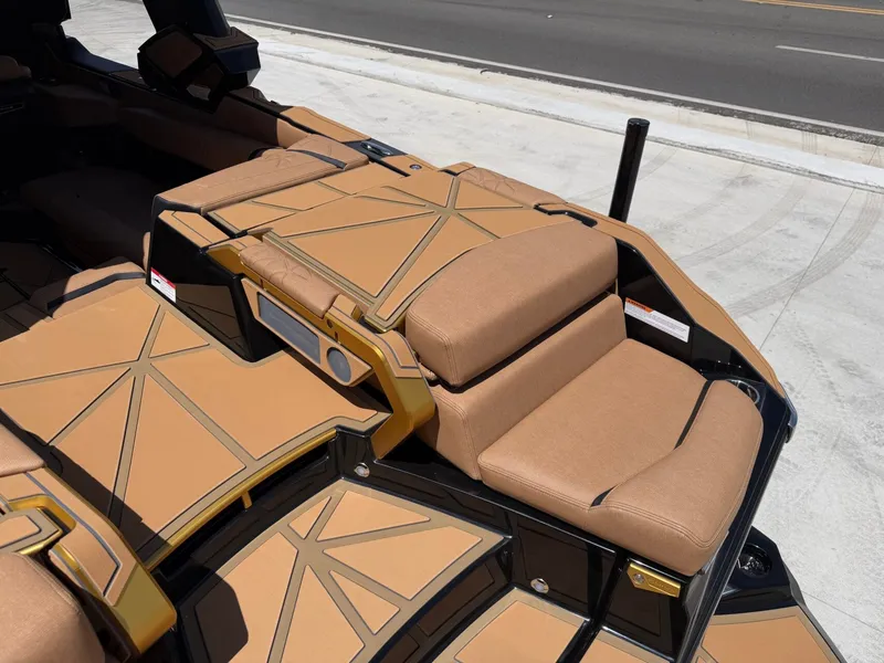 Slide: The Image of The image shows the luxurious, cushioned deck of a Nautique Super Air Nautique G23 Paragon boat. - 11