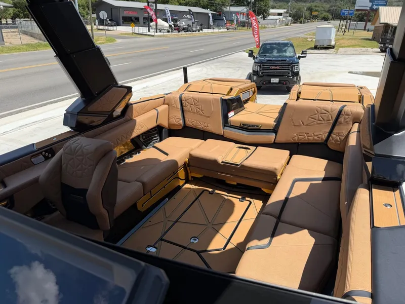 Slide: The Image of The image shows the luxurious interior of a Nautique Super Air Nautique G23 Paragon with beige upholstery. - 34
