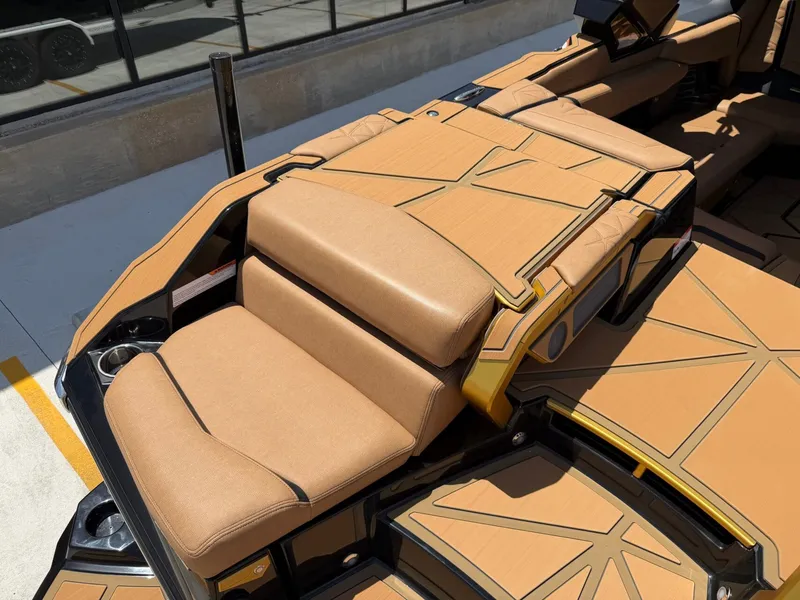 Slide: The Image of The image shows the luxurious, cushioned seating of a Nautique Super Air Nautique G23 Paragon boat. - 12