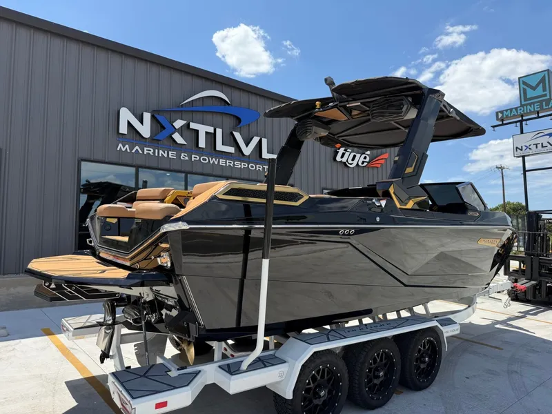 Slide: The Image of A sleek black boat on a trailer in front of a building. It features modern lines and luxurious details. - 3