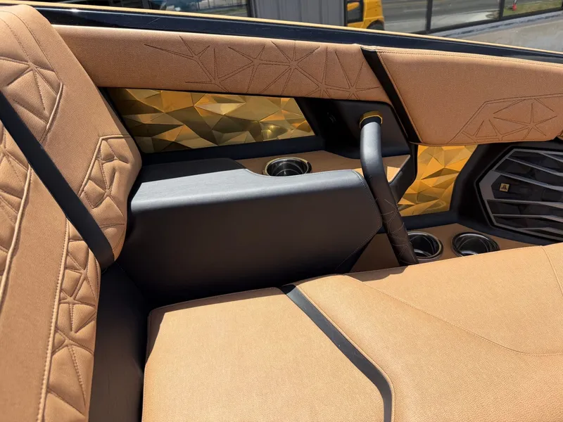 Slide: The Image of Luxurious interior with gold accents and plush seating in the Nautique Super Air Nautique G23 Paragon. - 30