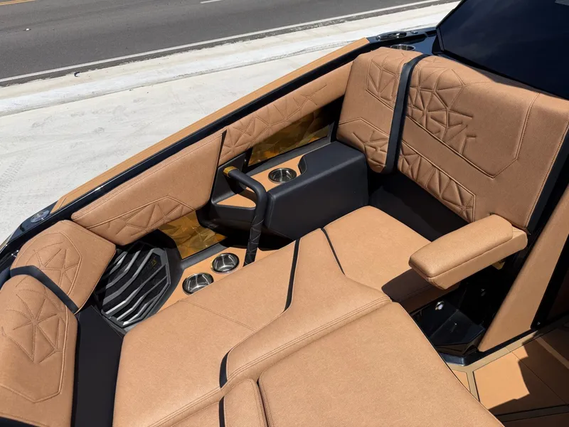 Slide: The Image of The interior of the 2027 Super Air Nautique G23 Paragon features luxurious beige upholstery with black accents. - 32