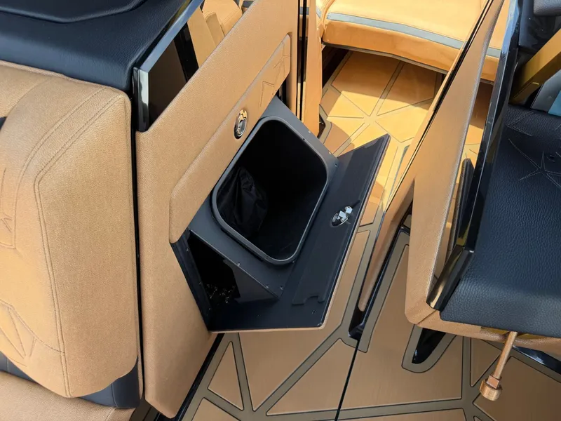 Slide: The Image of Interior of a Nautique Super Air Nautique G23 Paragon with sleek, modern upholstery and an open storage compartment. - 27