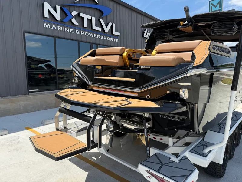 Slide: The Image of The image shows a luxurious motorboat on a trailer in front of a building. It features a sleek black and brown design. - 9