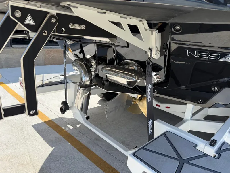 Slide: The Image of The image shows the rear section of a 2027 Nautique Super Air Nautique G23 Paragon with shiny exhaust pipes and a propeller. - 10