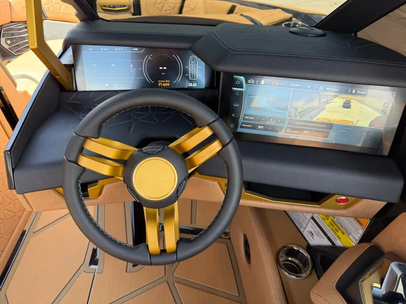 Slide: The Image of The cockpit of the 2027 Nautique Super Air Nautique G23 Paragon features a modern steering wheel and digital displays. - 25