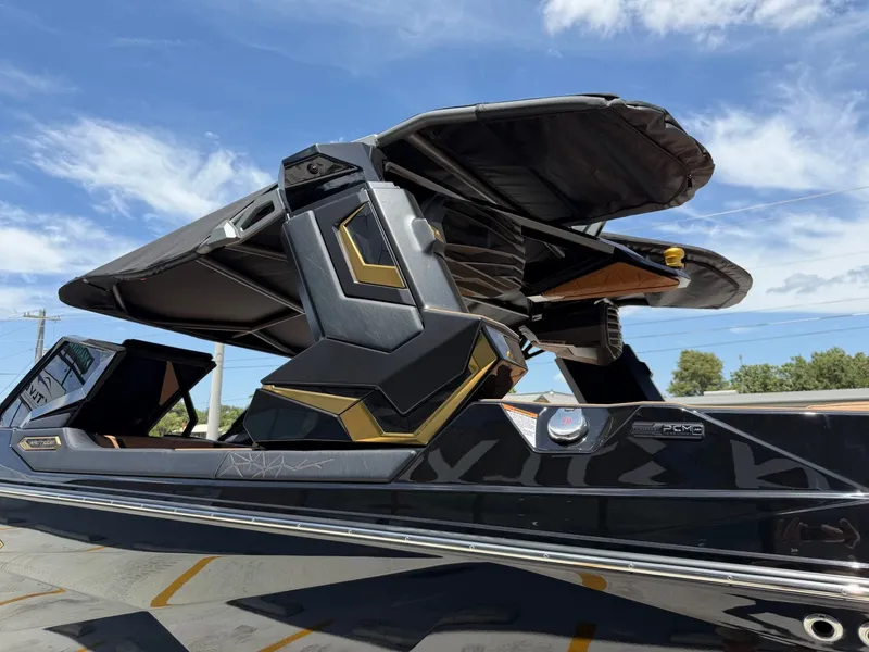 Slide: The Image of The image shows a luxurious boat with a sleek black design and gold accents. - 8
