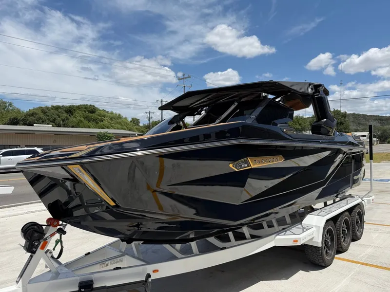 Slide: The Image of A sleek black boat on a trailer, featuring a modern design with gold accents. - 6
