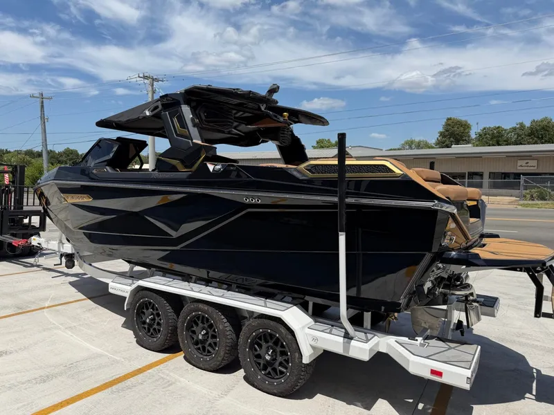 Slide: The Image of A sleek black boat with gold accents sits on a trailer. It features a modern design. - 7