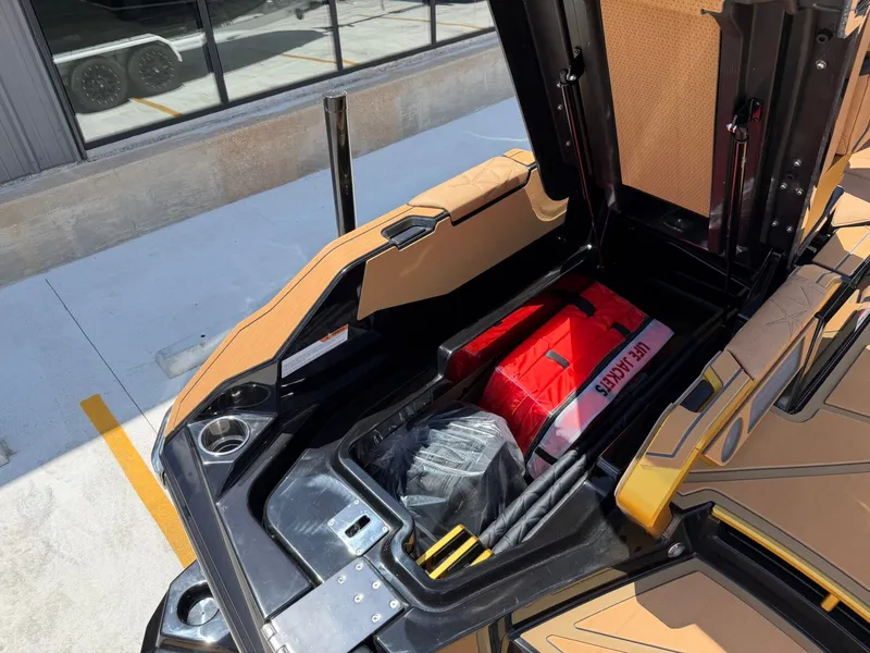 Slide: The Image of An open storage compartment of a Nautique Super Air Nautique G23 Paragon with life jacket and accessories. - 14