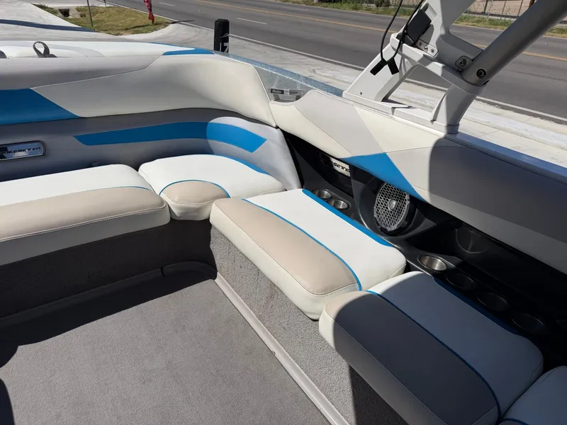Slide: The Image of The image shows the interior of a 2016 Malibu Wakesetter 23 LSV with beige and blue seating. - 12