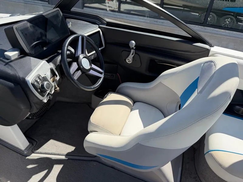 Slide: The Image of The image shows the cockpit of a 2016 Malibu Wakesetter 23 LSV with a modern steering wheel and large display. - 17