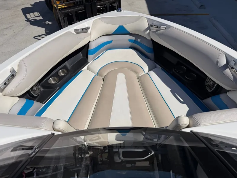 Slide: The Image of The image shows the bow of a 2016 Malibu Wakesetter 23 LSV with beige and blue upholstery. - 10