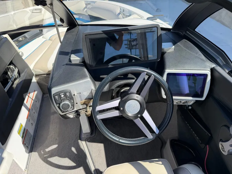 Slide: The Image of The image shows the cockpit of a 2016 Malibu Wakesetter 23 LSV with modern instruments. - 18