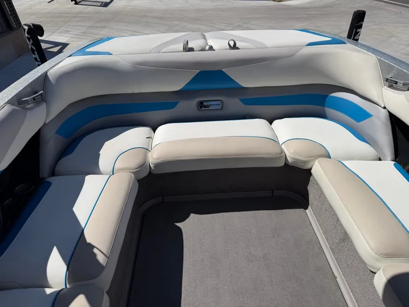 Slide: The Image of The image shows the rear seating of a 2016 Malibu Wakesetter 23 LSV with white and blue upholstery. - 13
