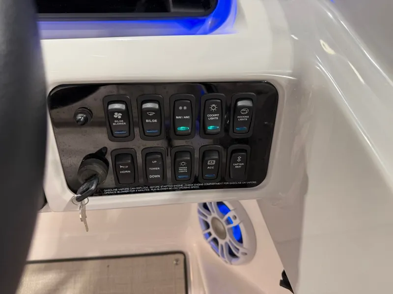 Slide: The Image of Close-up of a control panel area with multiple switches and an ignition key. - 25