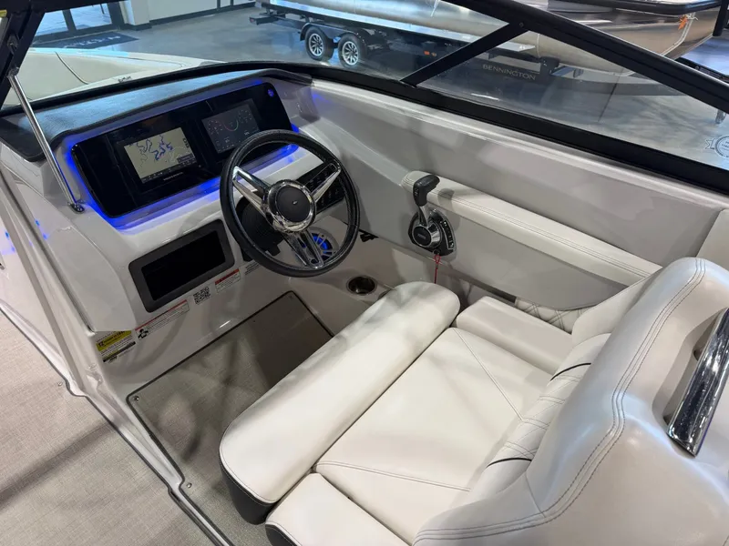 Slide: The Image of The image shows the cockpit of a 2022 Regal LS2 Surf boat with a modern helm. - 22