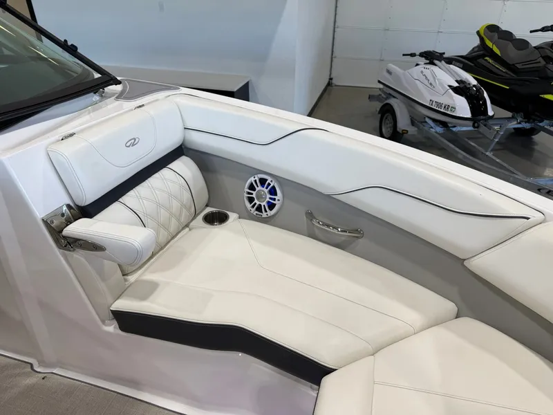 Slide: The Image of The image shows the interior of a 2022 Regal LS2 Surf boat with white upholstery. - 29