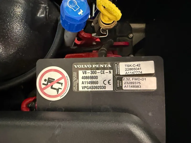 Slide: The Image of Close-up of a Volvo Penta V8-300 engine with technical details and warning labels. - 32